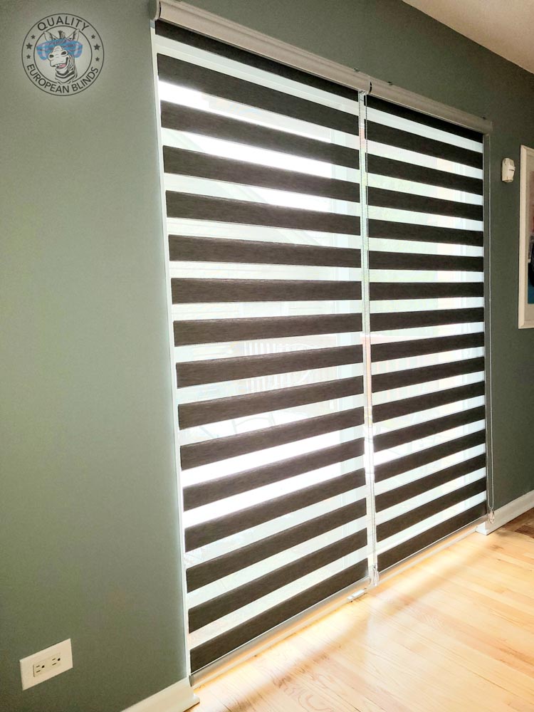 Charcoal zebra blinds installed on a tall patio door