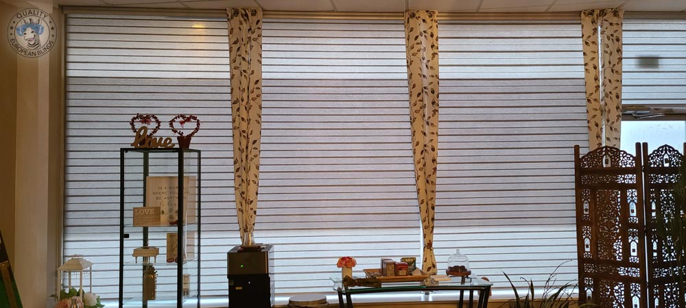 Zebra blinds fitted across wide commercial windows