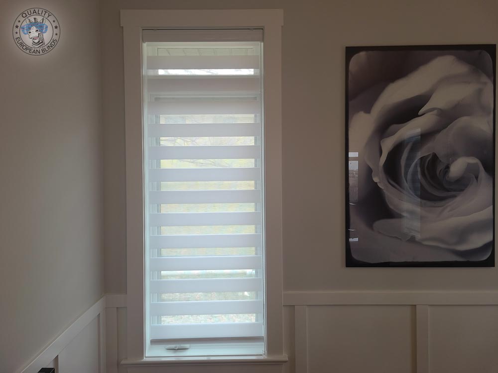 White zebra blind fitted to a narrow feature window